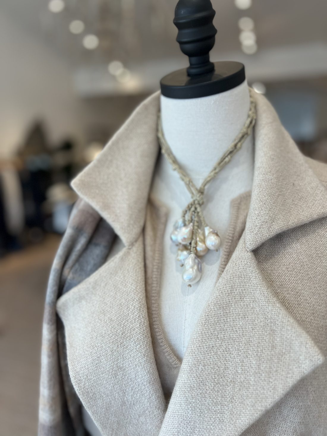 A Maison K coat styled with jewelry in the boutique