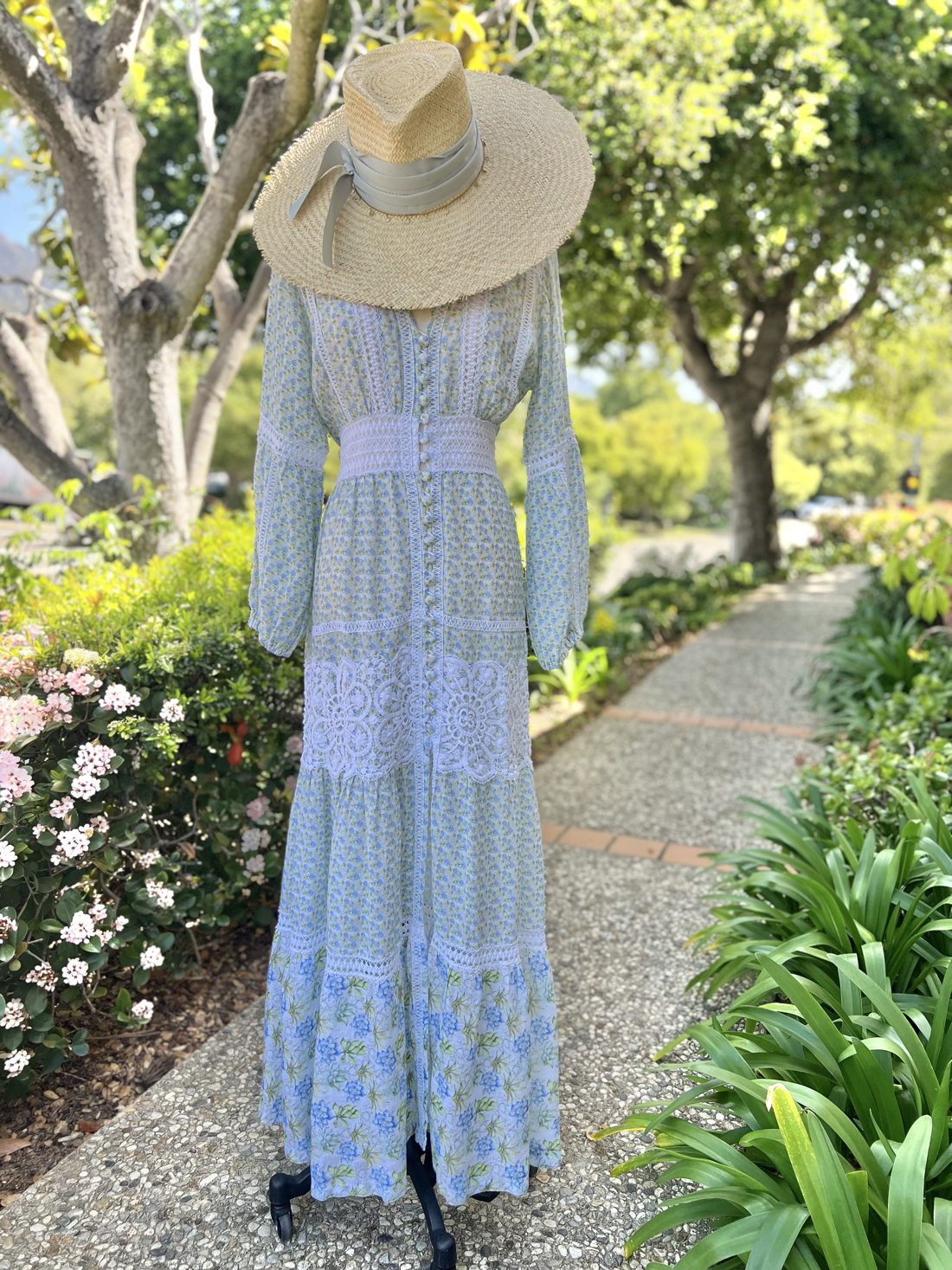 Pale blue dress and straw hat in the Montecito garden light